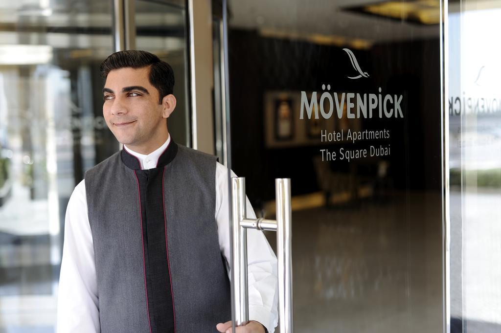 Moevenpick Hotel Apartments Al Mamzar Дубай Екстер'єр фото A doorman at a hotel in Dubai